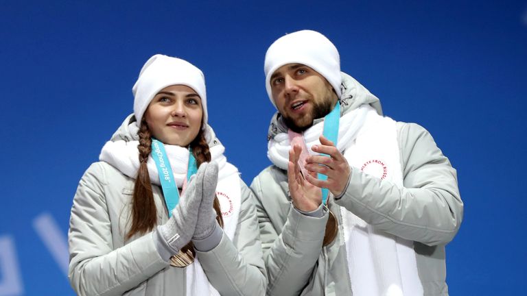 Russia's Anastasia Bryzgalova and Alexander Krushelnitsky receive their Bronze medal for Mixed Doubles Curling