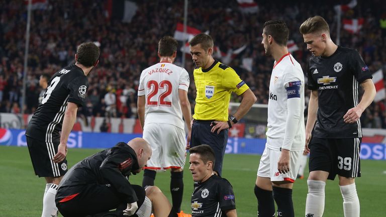 Manchester United midfielder Ander Herrera receives treatment on pitch against Sevilla