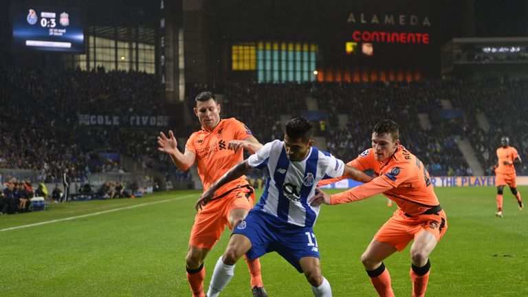 Porto's Mexican striker Jesus Corona (C) is closed down by Liverpool's English midfielder James Milner (L) and Liverpool's Scottish defender Andrew Roberts