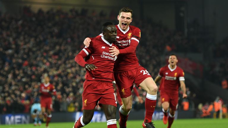 LIVERPOOL, ENGLAND - JANUARY 14:  Sadio Mane of Liverpool celebrates with team mate Andy Robertson after scoring the third Liverpool goal during the Premie