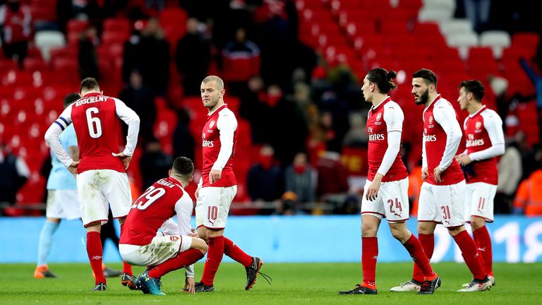 Arsenal players look dejected after being beaten 3-0 by Manchester City in the Carabao Cup final