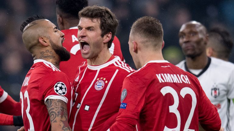 Bayern Munich's midfielder Thomas Mueller (C) celebrates with teammates after scoring a goal during the UEFA Champions League round of sixteen first leg fo