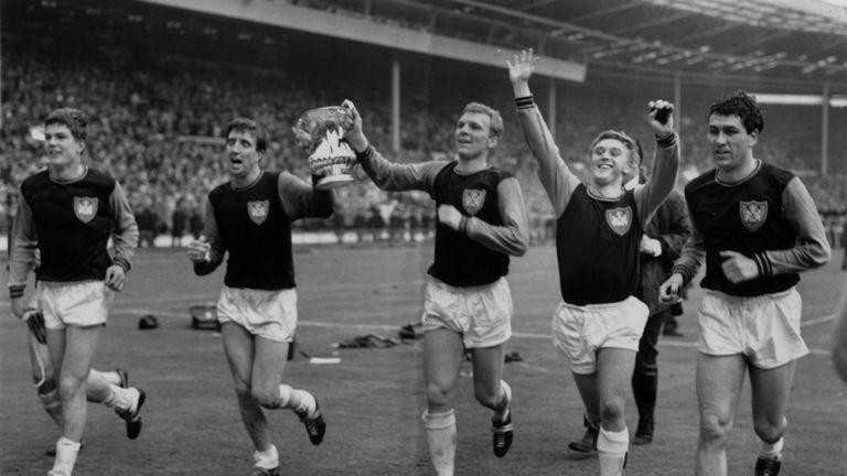 Bobby Moore (centre) celebrates winning the 1964 FA Cup with his West Ham team mates