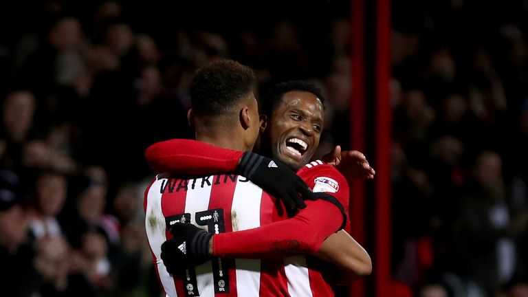 BRENTFORD, ENGLAND - FEBRUARY 20:  Ollie Watkins of Brentford celebrates with teammate Florian Jozefzoon after scoring the first Brentford goal during the 