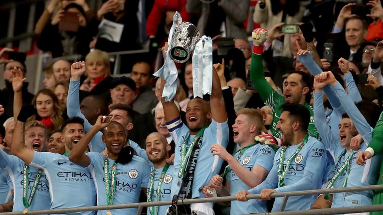 LONDON, ENGLAND - FEBRUARY 25:  Vincent Kompany of Manchester City lifts the trophy after winning the Carabao Cup Final between Arsenal and Manchester City