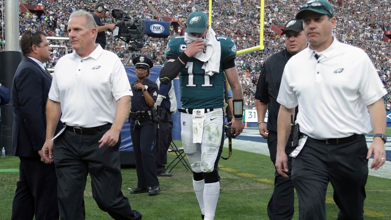 LOS ANGELES, CA - DECEMBER 10:  Carson Wentz #11 of the Philadelphia Eagles is escorted off the field at the end of the third quarter during the game again