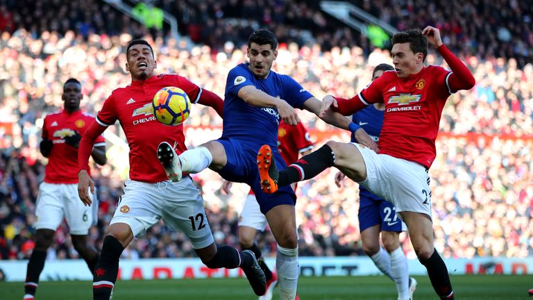 MANCHESTER, ENGLAND - FEBRUARY 25:  Alvaro Morata of Chelsea, Victor Lindelof and Chris Smalling of Manchester United compete for the ball during the Premi