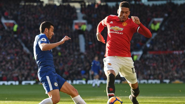 Manchester United's English defender Chris Smalling (R) clears the ball away from Chelsea's Spanish midfielder Pedro during the English Premier League foot