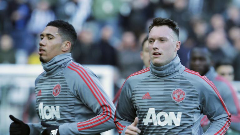 Chris Smalling and Phil Jones warm up ahead of the Premier League match between Newcastle United and Manchester United at St. James Park