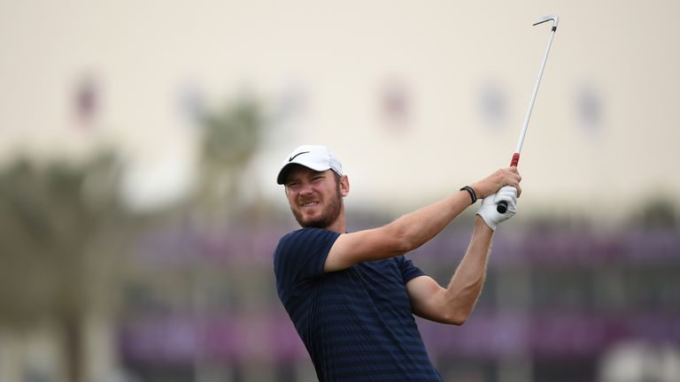 DOHA, QATAR - FEBRUARY 22:  Chris Wood of England hits an approach shot on the 1st hole during the first round of the Commercial Bank Qatar Masters at Doha