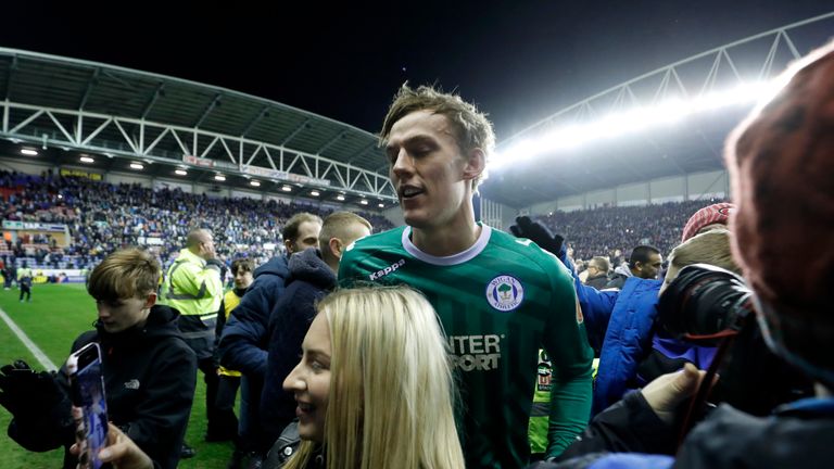 Wigan Athletic's Christian Walton is mobbed by fans after the Emirates FA Cup, Fifth Round match at the DW Stadium, Wigan.