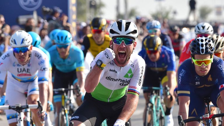 Dimension Data's British rider Mark Cavendish (C) celebrates his victory as he crosses the finish line during the third stage of the Dubai Tour