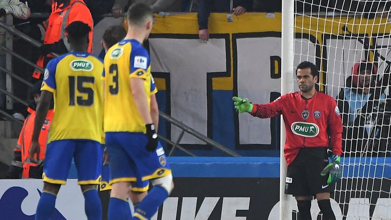 Paris Saint-Germain's Brazilian defender Daniel Alves (R) plays as goalkeeper after Paris Saint-Germain's German goalkeeper Kevin Trapp received a red card