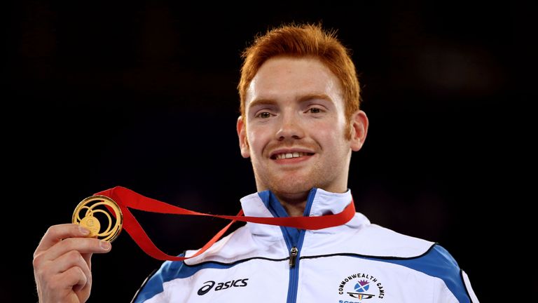 Gold medalist Daniel Purvis of Scotland poses during the medal ceremony for the Men's Parallel Bars Final at SSE Hydro durin
