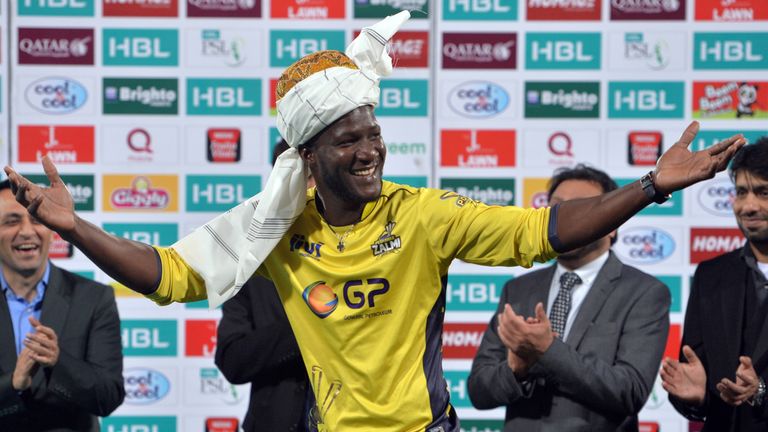 CORRECTION - Peshawar Zalmi captain West Indies Darren Sammy (C) wears a traditional turban as he celebrates with teammates his team's victory over Quetta 