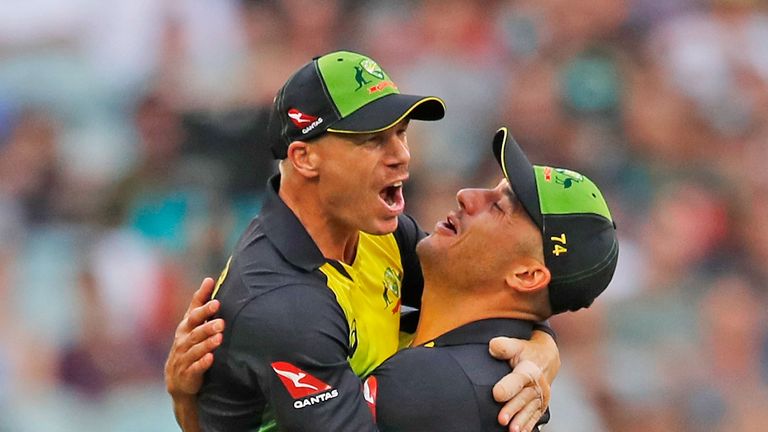 David Warner of Australia celebrates with Marcus Stoinis after running out Dawid Malan of England