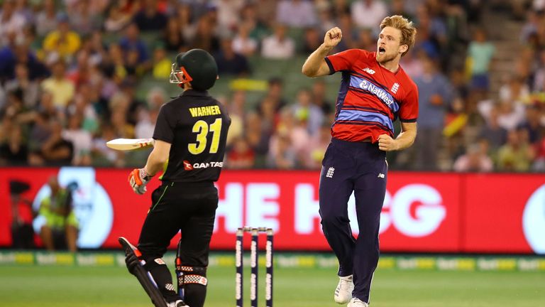 MELBOURNE, AUSTRALIA - FEBRUARY 10:  David Warner of Australia looks dejected as David Willey of England celebrates taking his wicket during game two of th