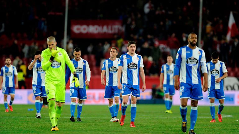 Deportivo La Coruna's players react during the Spanish league football match Sevilla FC vs RC Deportivo de la Coruna at the Ramon Sanchez Pizjuan stadium i