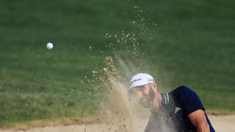 ABU DHABI, UNITED ARAB EMIRATES - JANUARY 21:  Dustin Johnson of the United States plays his third shot on the first hole during the final round of the Abu