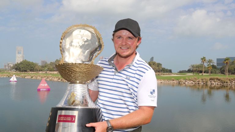 Eddie Pepperell of England poses with the winners trophy after winning the final round of the Qatar Masters golf tournament at the Doha Golf Club in Doha, 