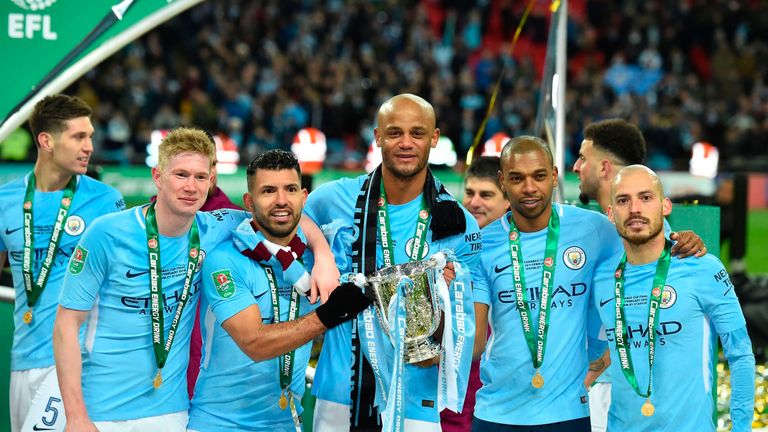 Kevin De Bruyne, Sergio Aguero, Vincent Kompany (C), Fernandinho (2nd R) and David Silva pose with the EFL Cup