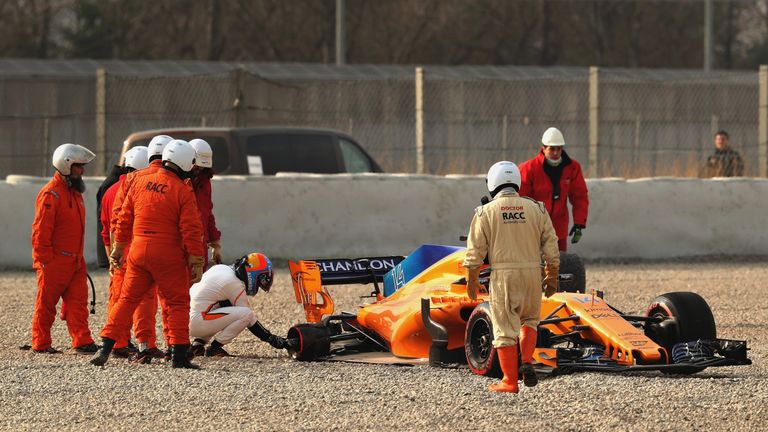 MONTMELO, SPAIN - FEBRUARY 26: Fernando Alonso of Spain and McLaren F1 checks over his car after stopping on track during day one of F1 Winter Testing at C