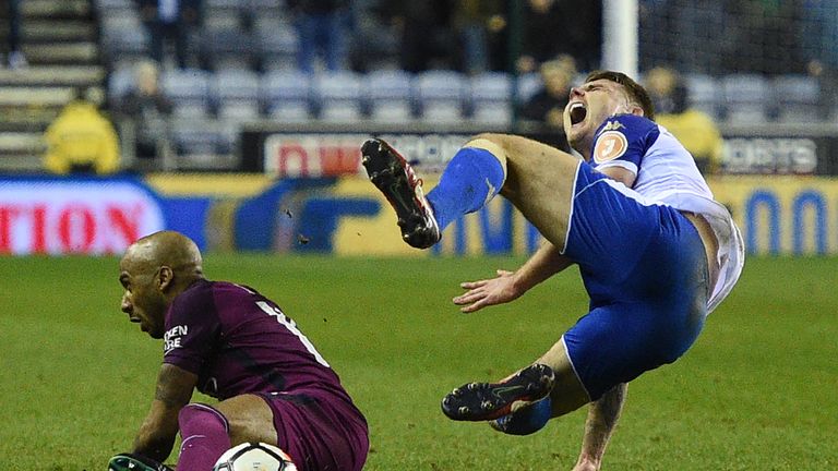 Manchester City's English midfielder Fabian Delph's (L) tackle on Wigan Athletic's English midfielder Max Power leads to a red card during the English FA C
