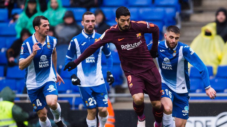 Luis Suarez of FC Barcelona conducts the ball under pressure from Victor Sanchez (L), Sergi Darder (2nd L) and David Lopez  v Espanyol