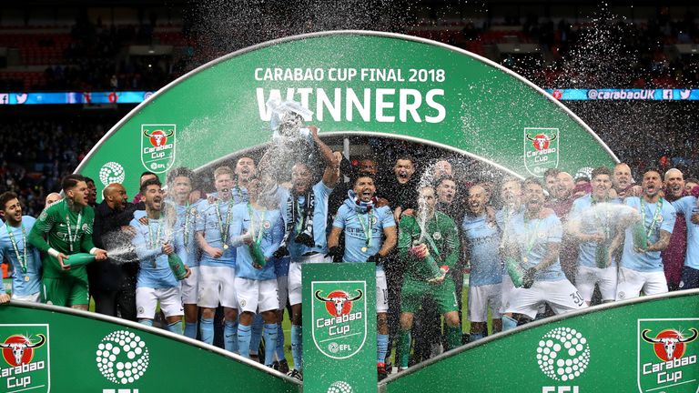 Vincent Kompany lifts the Carabao Cup trophy as Manchester City players celebrate their 3-0 victory over Arsenal