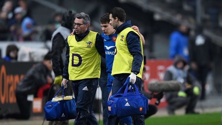 France's Antoine Dupont is led off the field after being injured against Ireland