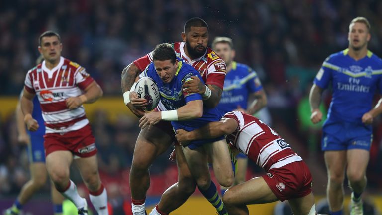 MANCHESTER, ENGLAND - OCTOBER 08:  Kurt Gidley of Warrington is held up by Frank-Paul Nuuausala (L) and (L) and Willy Isa  (R) of Wigan during the First Ut