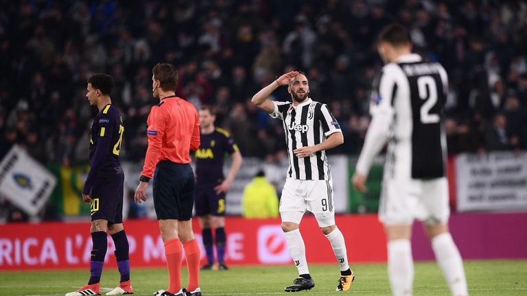 Juventus' forward from Argentina Gonzalo Higuain (C) celebrates after scoring during the UEFA Champions League round of sixteen first leg football match be