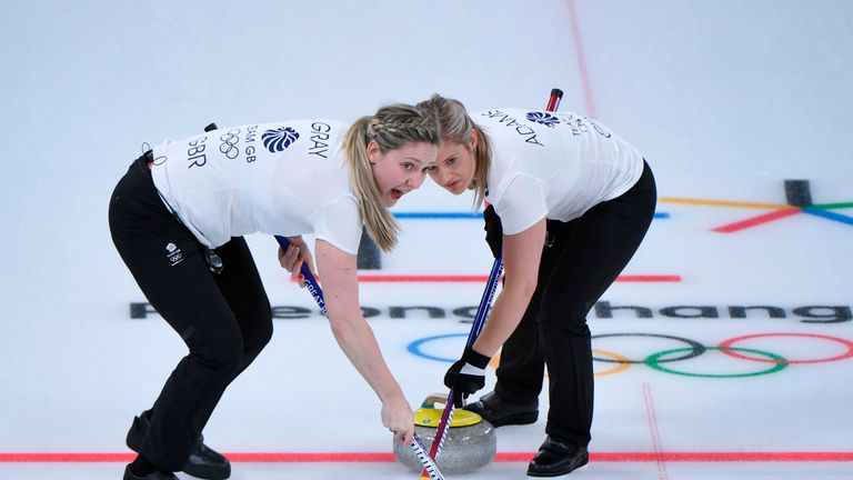 Britain's Lauren Gray (L) and Britain's Vicki Adams brush in front of the stone at the  Winter Olympic Athletes