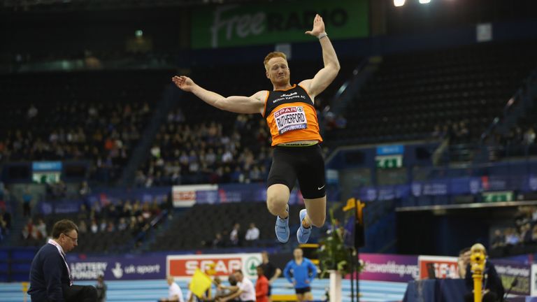 Greg Rutherford competes in the long jump at British Indoor Championships