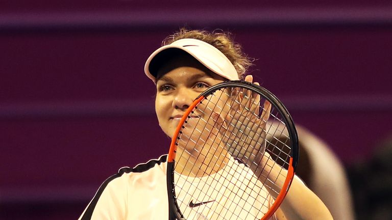 Romanian tennis player Simona Halep celebrates after winning her singles match against Russian player Ekaterina Makarova in the second round of the Qatar O
