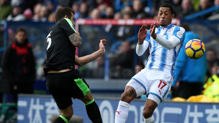 Steve Cook of AFC Bournemouth clashes with Rajiv van La Parra of Huddersfield Town during the Premier League match be