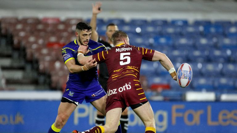 Aaron Murphy offloads while seeing off the attentions of Warrington's Declan Patton 