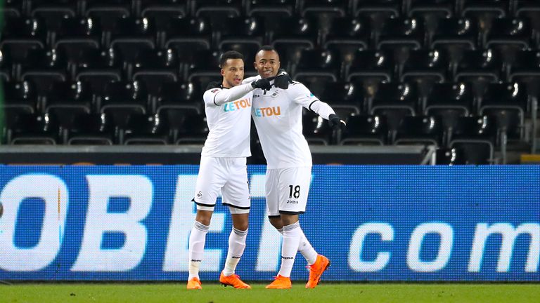 Swansea City's Jordan Ayew (right) celebrates scoring his side's first goal of the game with team mate Martin Olsson during the Emirates FA Cup, fifth roun