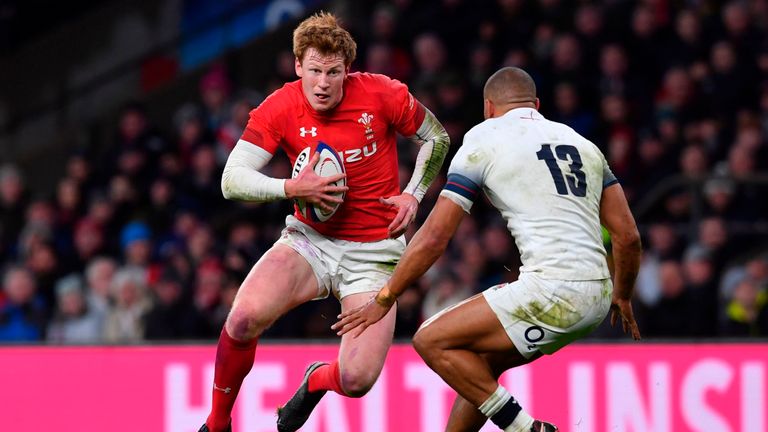 Wales' fly-half Rhys Patchell (L) takes on England's centre Jonathan Joseph (R) during the Six Nations international rugby union match between England and 