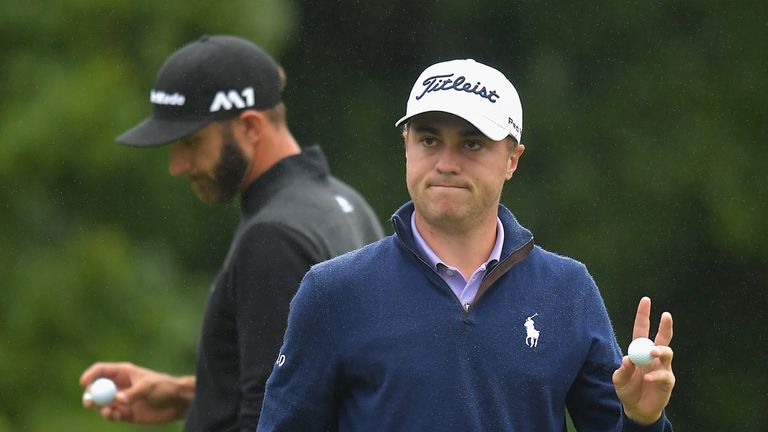 NORTON, MA - SEPTEMBER 03:  Justin Thomas of the United States (R) acknowledges fans after putting on the 18th green as Dustin Johnson of the United States