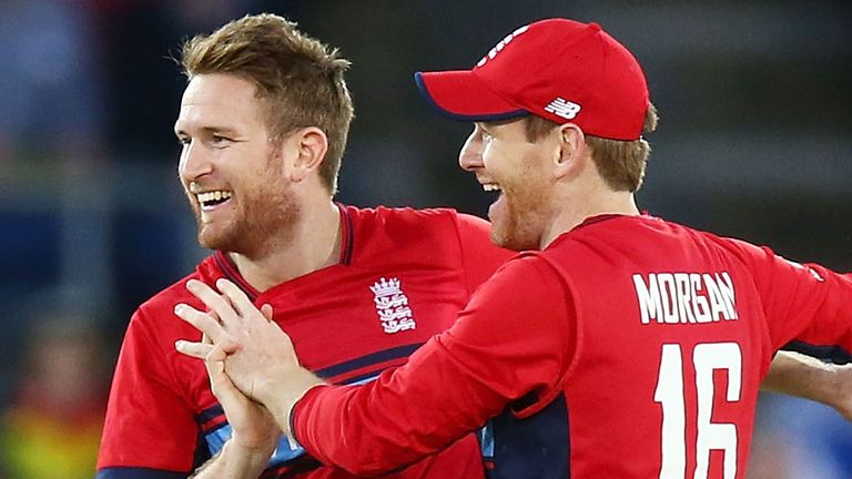 Skipper Eoin Morgan congratulates spinner Liam Dawson, who took 3-16