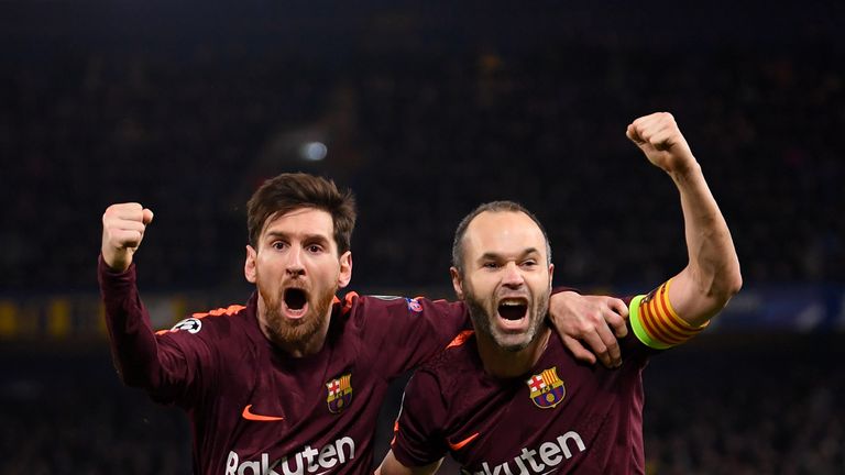 LONDON, ENGLAND - FEBRUARY 20:  Lionel Messi of Barcelona celebrates with teammate Andres Iniesta after scoring his sides first goal during the UEFA Champi