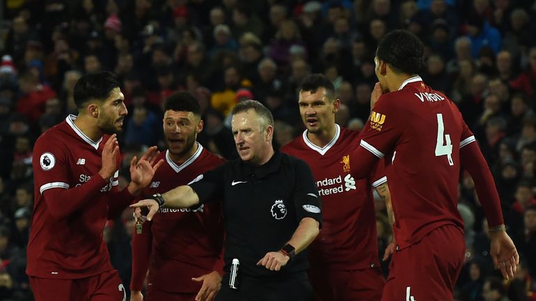 Referee Johnathan Moss (C) awards the first penalty as Liverpool players discuss during the English Premier League football match between Liverpool and Tot