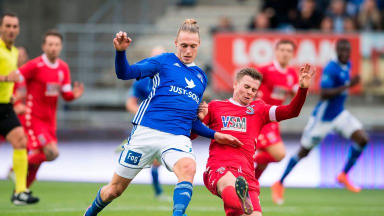 Lyngby's Jesper Christjansen (L) and Bangor City FC's Steven Daniel Hewitt vie for the ball during their UEFA Europa League qualifying match on June 29, 20