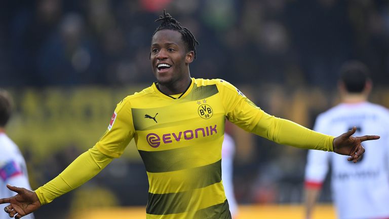 Michy Batshuayi of Dortmund is challenged by of Hamburg during the Bundesliga match between Borussia Dortmund and Hamburger SV