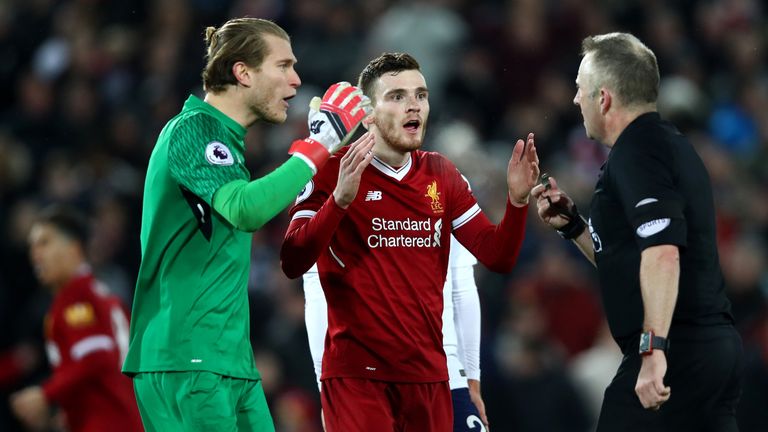 Loris Karius and Andy Robertson confront referee Jonathan Moss