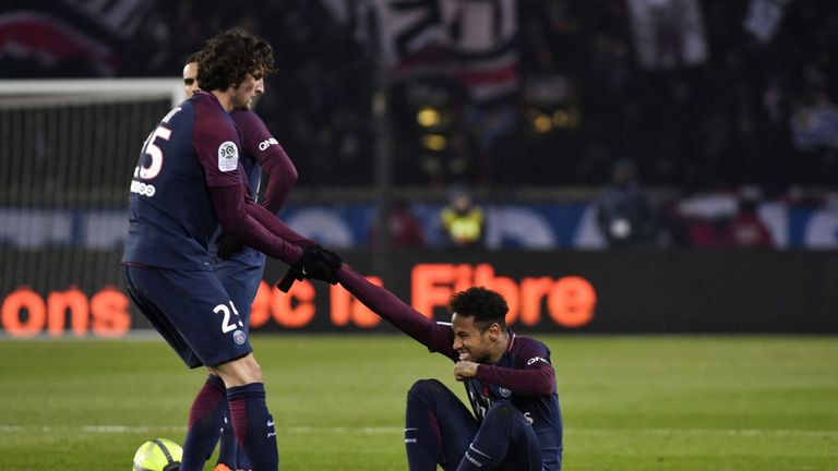 Paris Saint-Germain's French midfielder Adrien Rabiot (L) helps Paris Saint-Germain's Brazilian forward Neymar Jr during the French L1 football match betwe