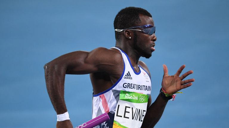 Britain's Nigel Levine runs with the baton in the Men's 4x400m Relay Round 1 during the athletics event at the Rio 2016 Olympic Games at the Olympic Stadiu