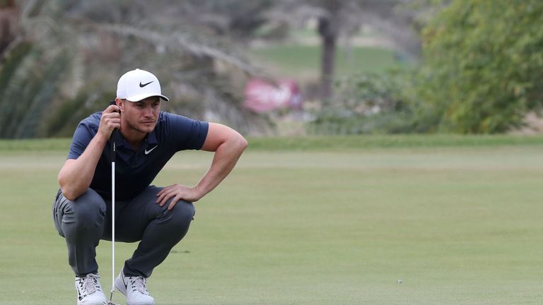 Oliver Fisher of England eyes the ball during the third round of the Qatar Masters golf tournament at the Doha Golf Club in Doha, on February 24, 2018.  / 