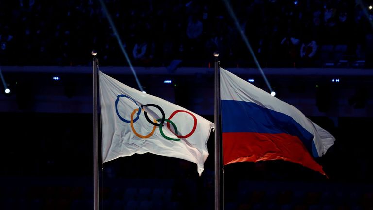 The Olympic flag flies next to the Russian flag